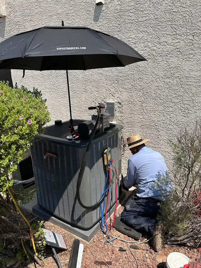 HVAC technician performing outdoor AC maintenance in Trinity